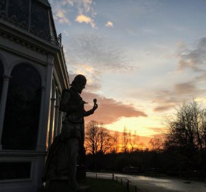 A statue of a man holding a rose. 