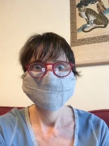 Naomi in a home-made face mask, face on.