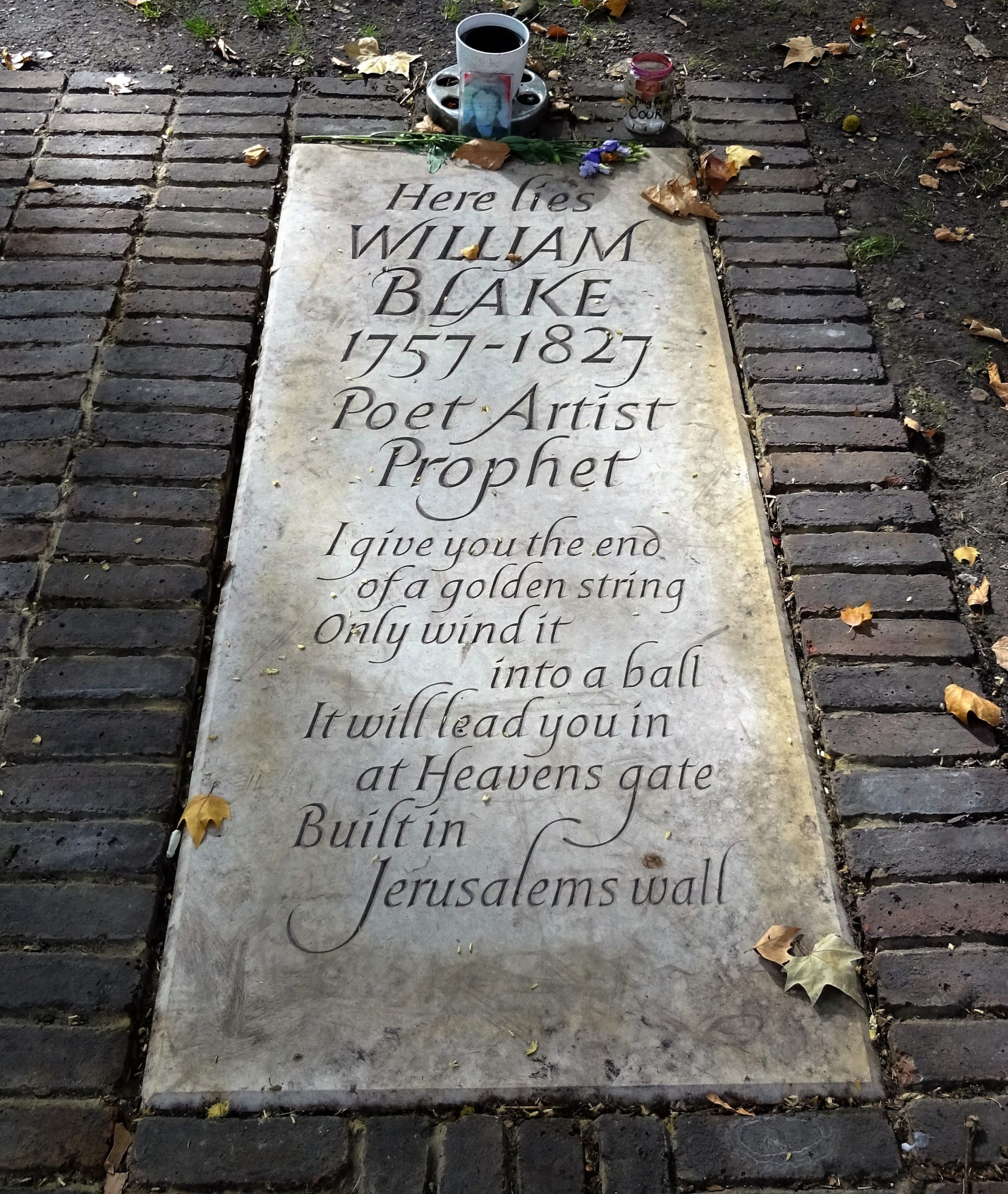 William Blake's headstone, with the quote: 'I give you the end of a golden thread, only wind it into a ball. It will lead you in at Heaven's gate, built in Jerusalem's wall.'
