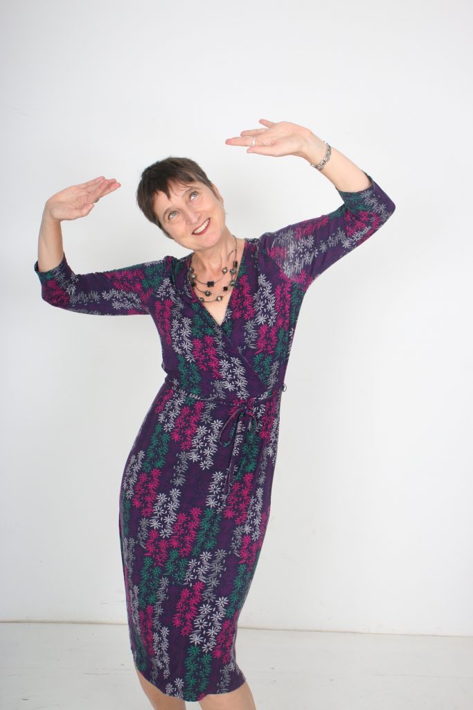 Naomi Foyle dancing, a smile on her face