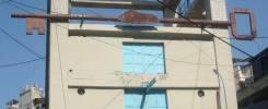a huge rusted key mounted on the side of a building in Shatila refugee camp